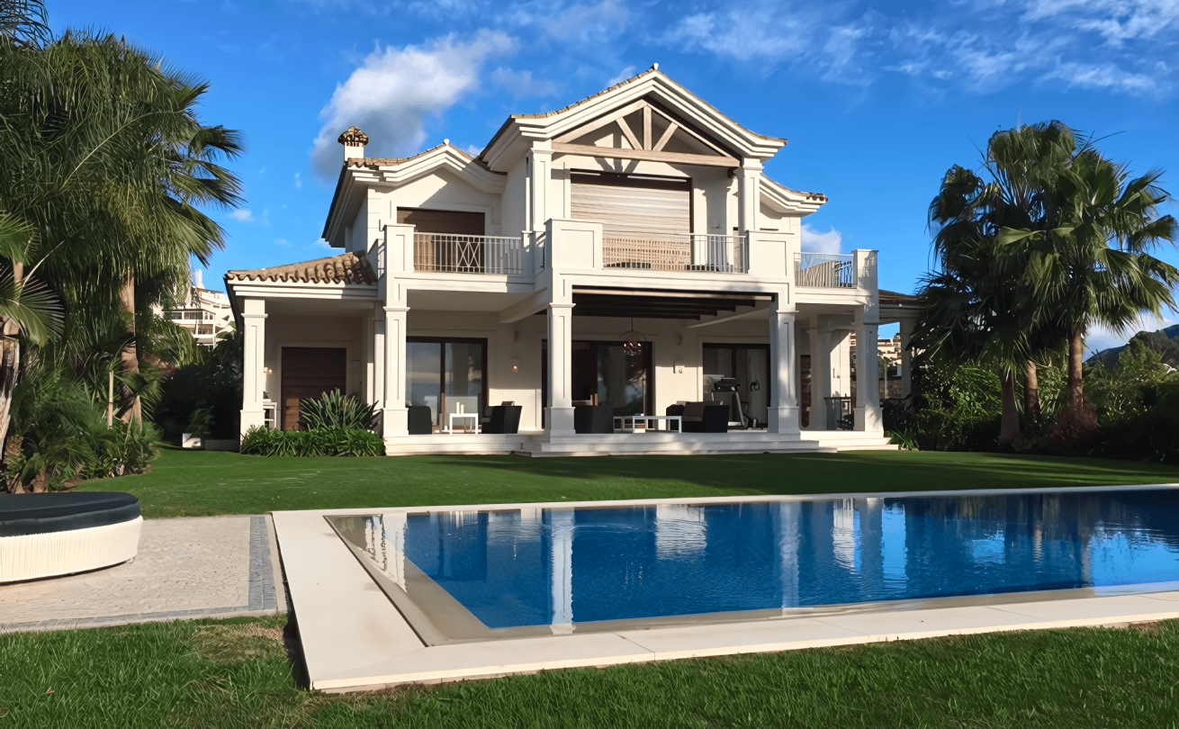 Outdoor dining area with a view of the La Cerquilla garden and villa.
