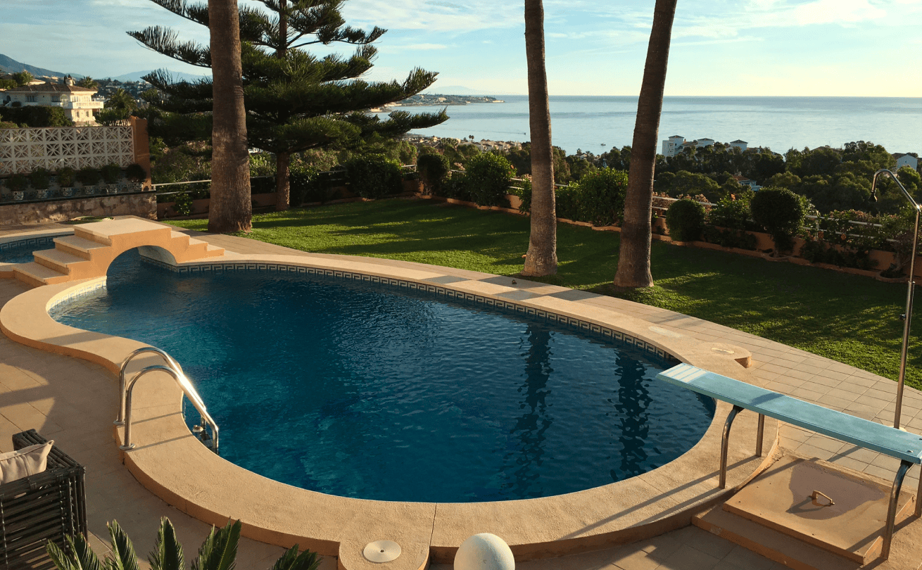 Pool view of Torre Nueva outdoor space featuring native flora and coastal-inspired landscaping.